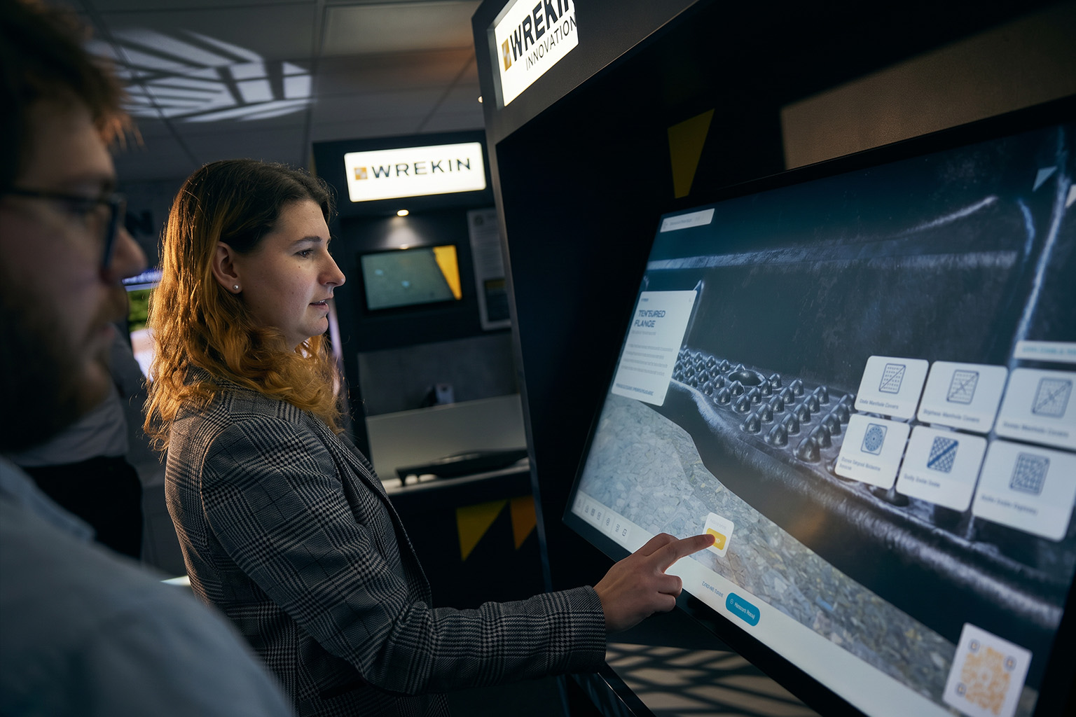 People using the Civils Hub interactive touch screen